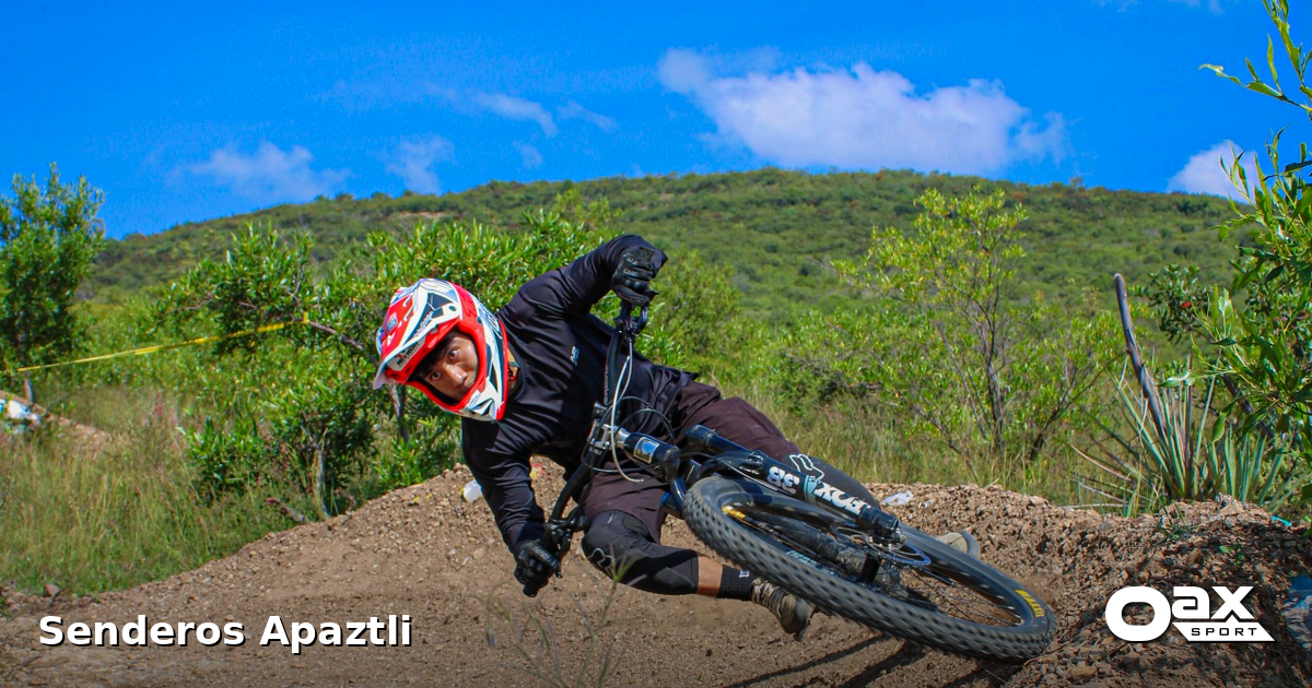 Mountain biker riding a hand-built dirt berm at Senderos Apaztli in Magdalena Apazco, Oaxaca