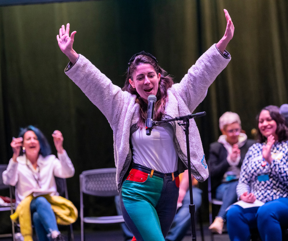 Participant of LTC Tenth Anniversary Convening Cristina Fernandez raises her hands with excitement