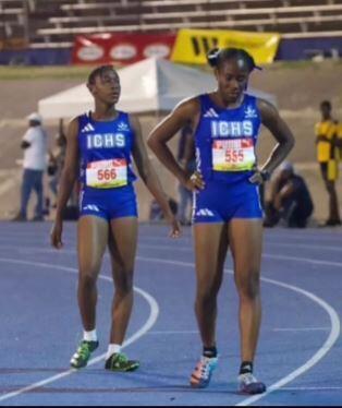 A couple of women in blue uniforms on a trackAI-generated content may be incorrect.