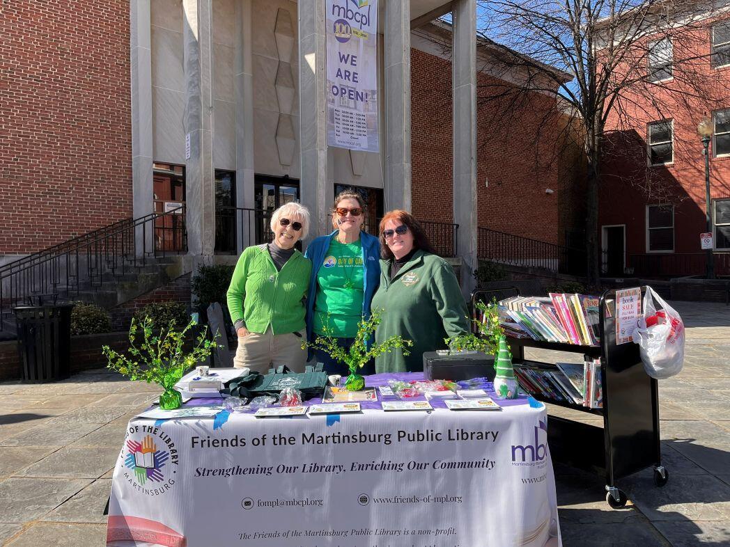Friends Members volunteering in the MBCPL plaza during the Martinsburg St. Patrick's Day festival.