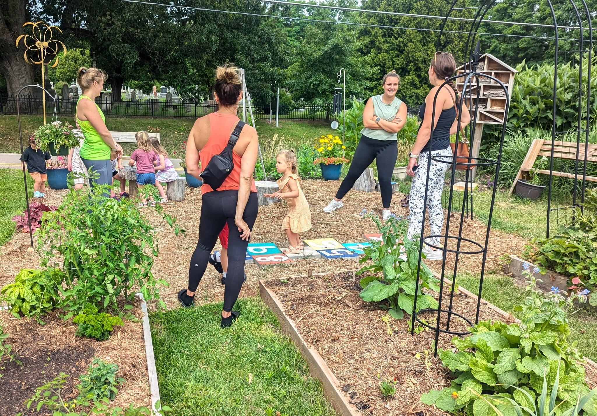 Children and parents interact in Community Garden at Cromaine