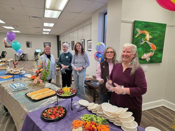 Friends Members stationed at the refreshment table during the  Ribbon cutting ceremony and reception at the Downtown Martinsburg Library.