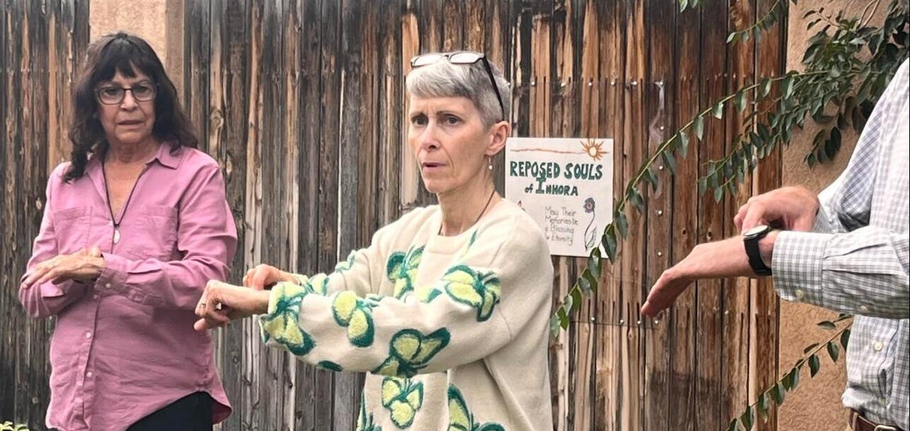 Two women and a man signing the ASL name for Inhora.